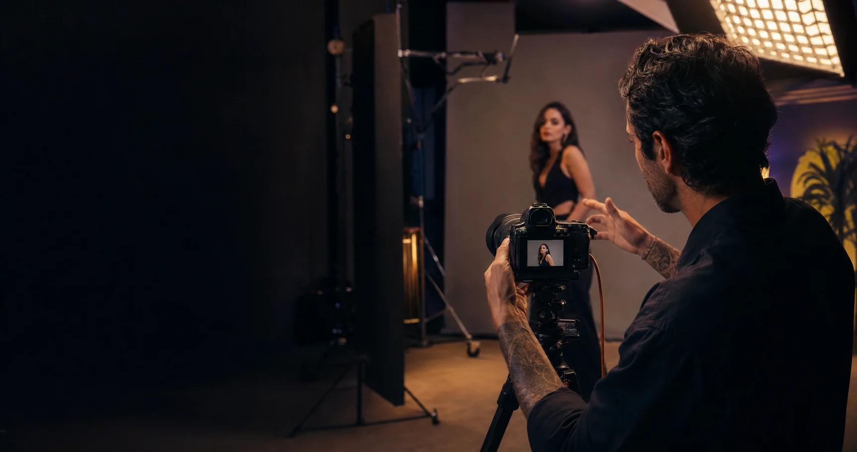 Commercial photographer directing a professional studio portrait session